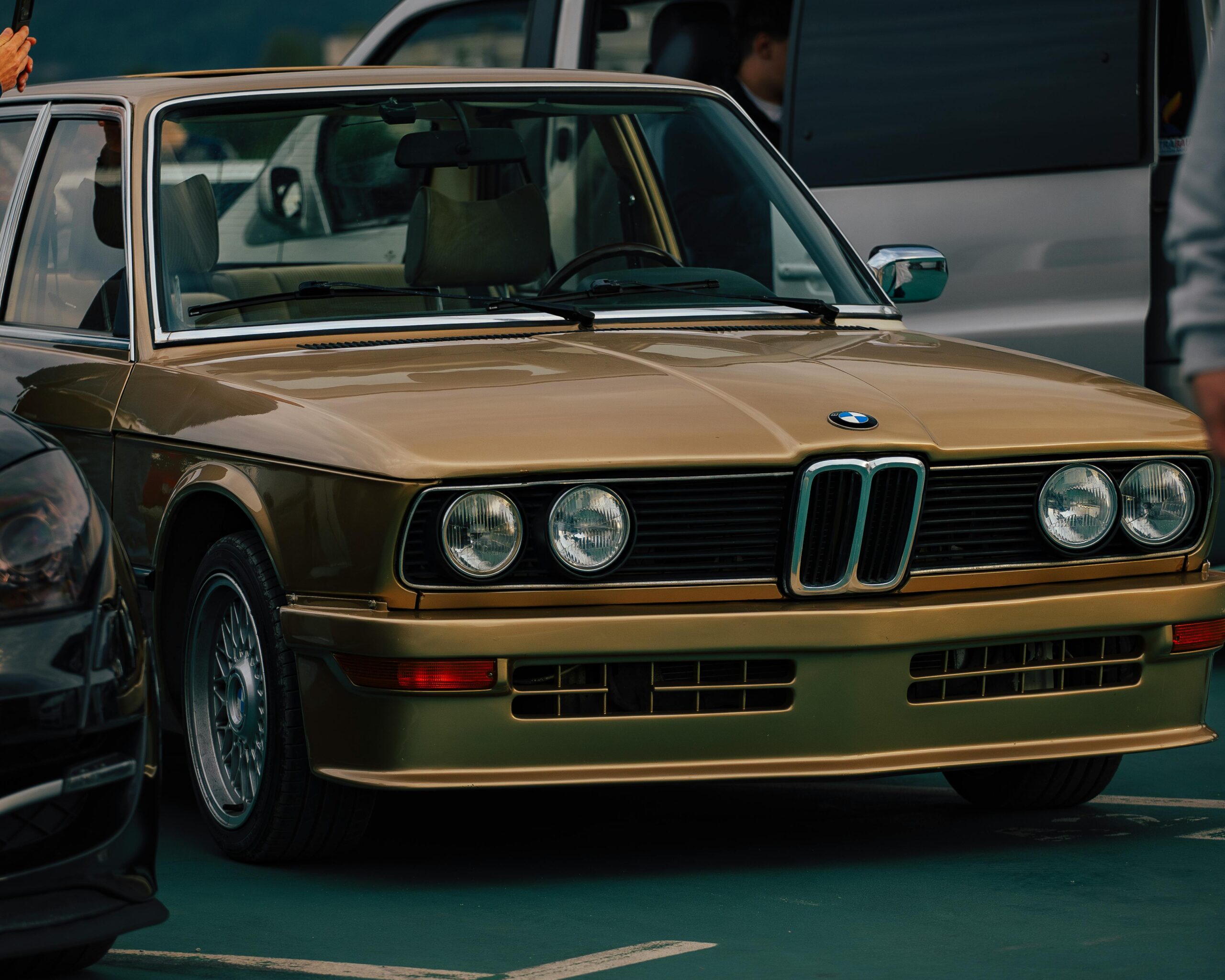Vintage gold BMW car showcased outdoors in Sarajevo, Bosnia and Herzegovina.
