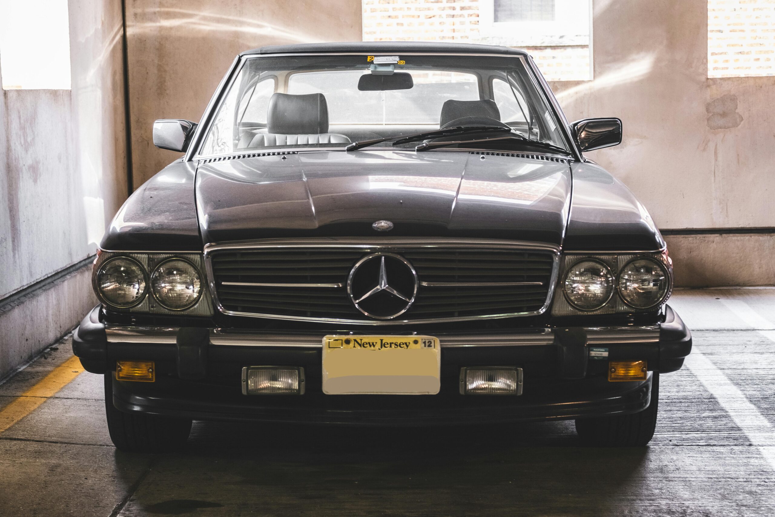 Classic Mercedes-Benz vehicle parked in an indoor lot with retro design and chrome details.